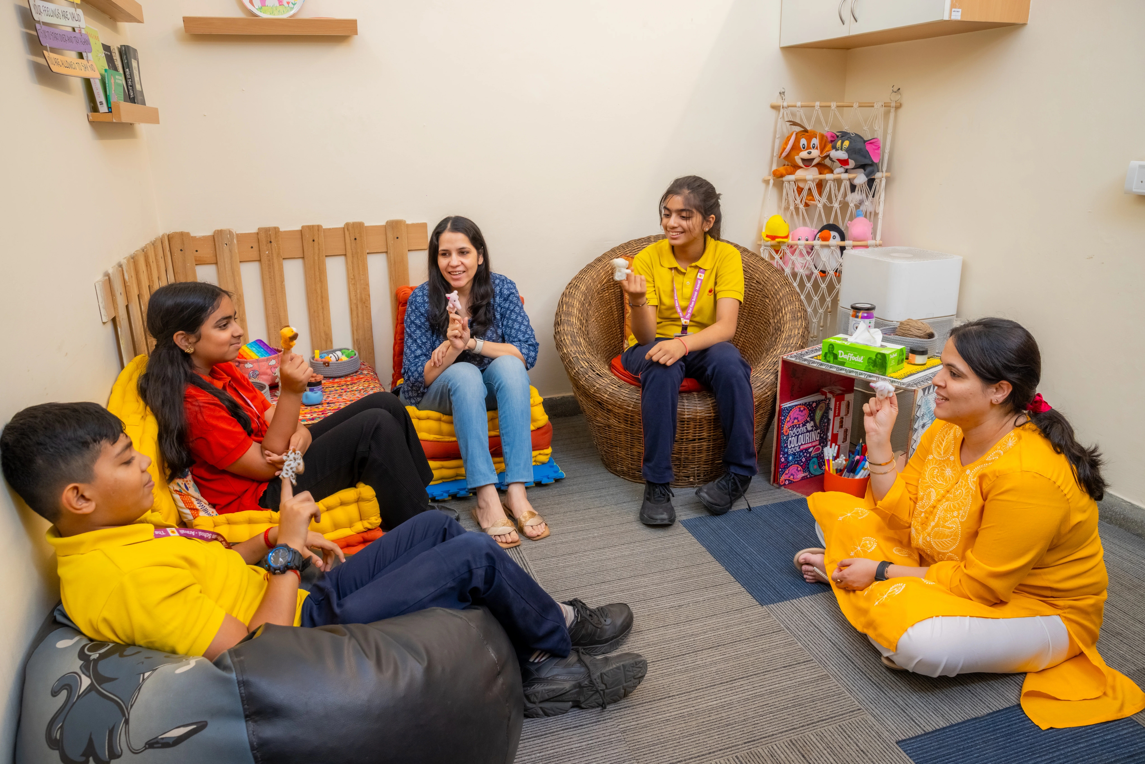 A counsellor talking with students in a school corridor at The Shri Ram School