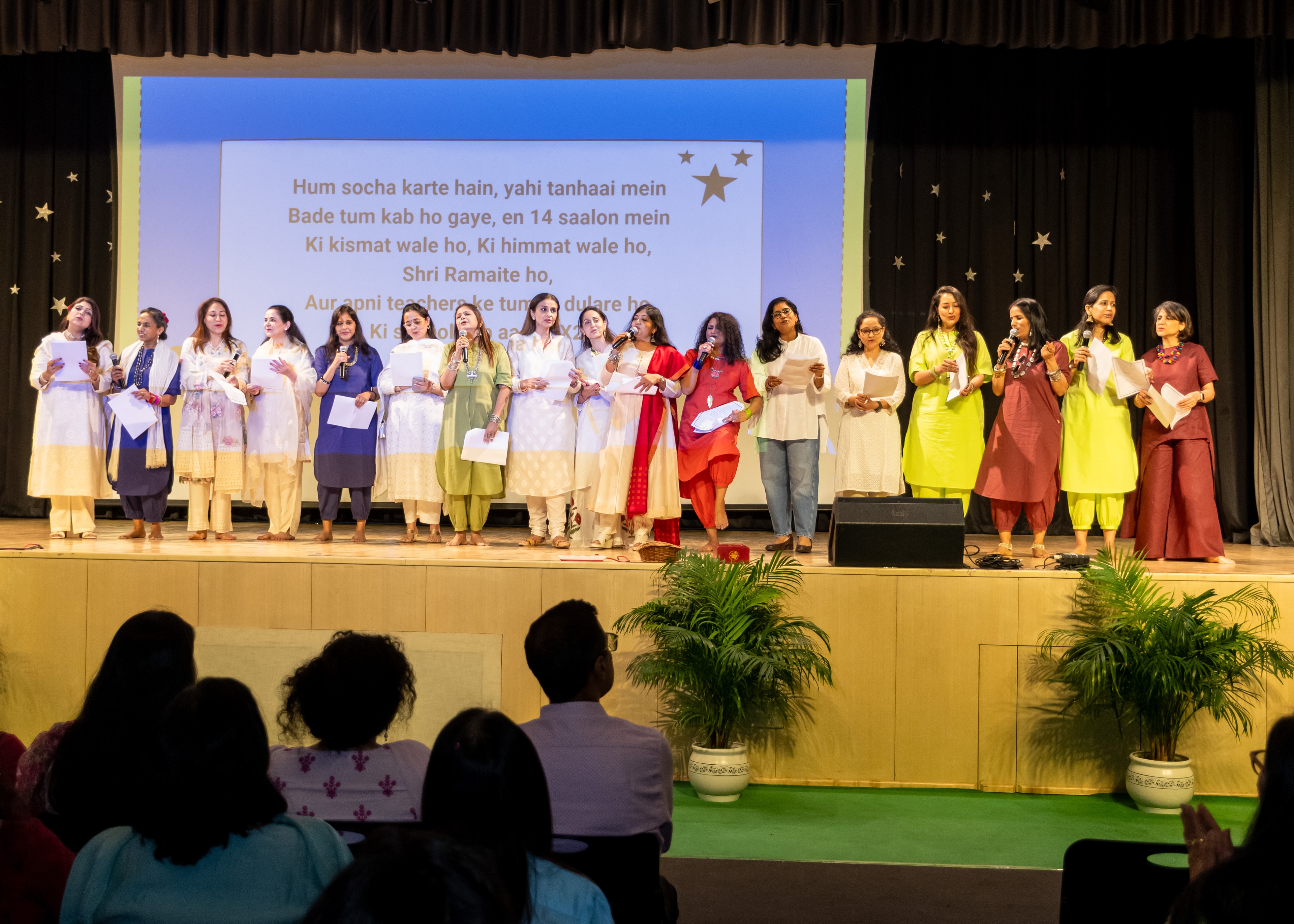 Students and staff gathered on stage at a school assembly